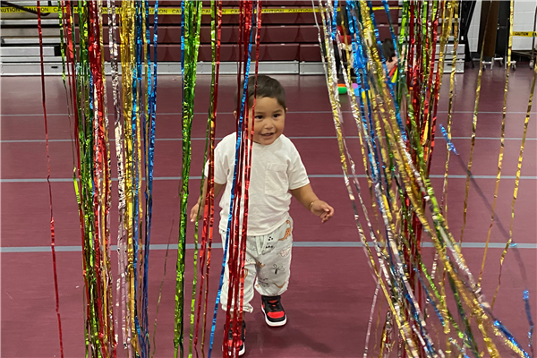 Matteo walking through streamers