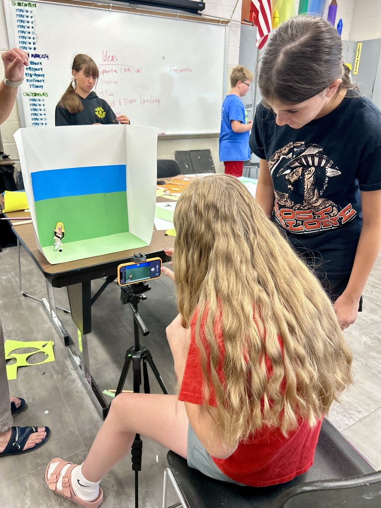 2 girls creating a stop motion video on their phone