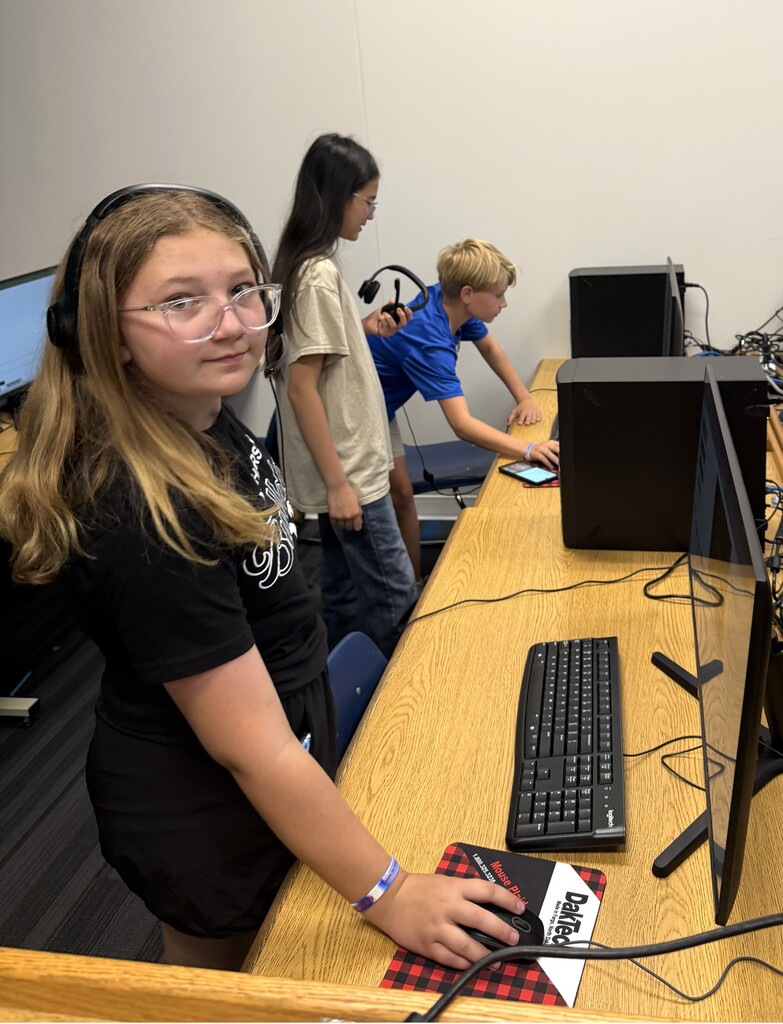 student with headphones on looking at camera