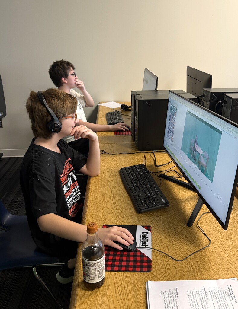 two students working on computer screen