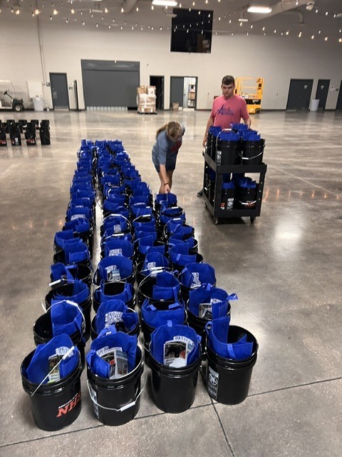 students working on moving buckets