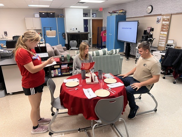 students working on setting table