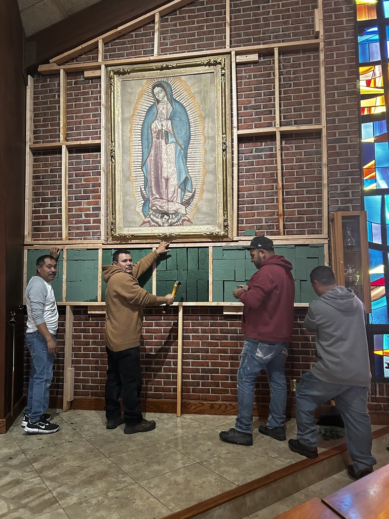 Wall of flowers under construction