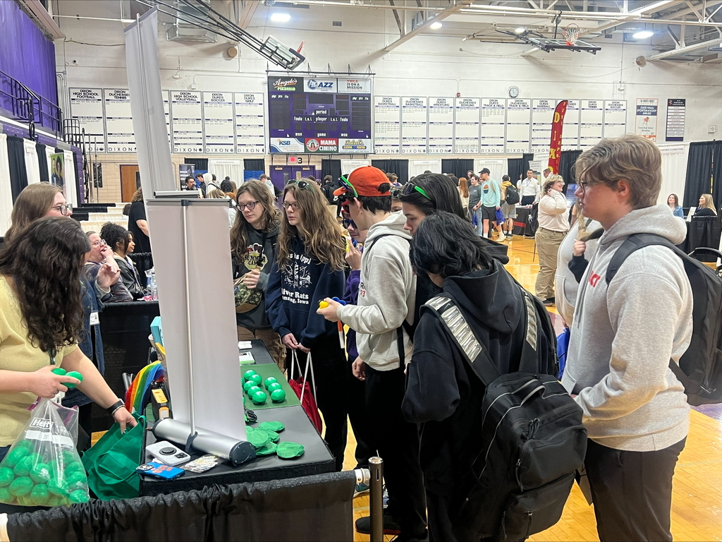 students at career fair listening to speakers at each booth