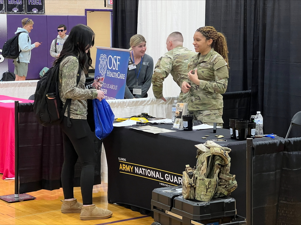 students at career fair listening to speakers at each booth