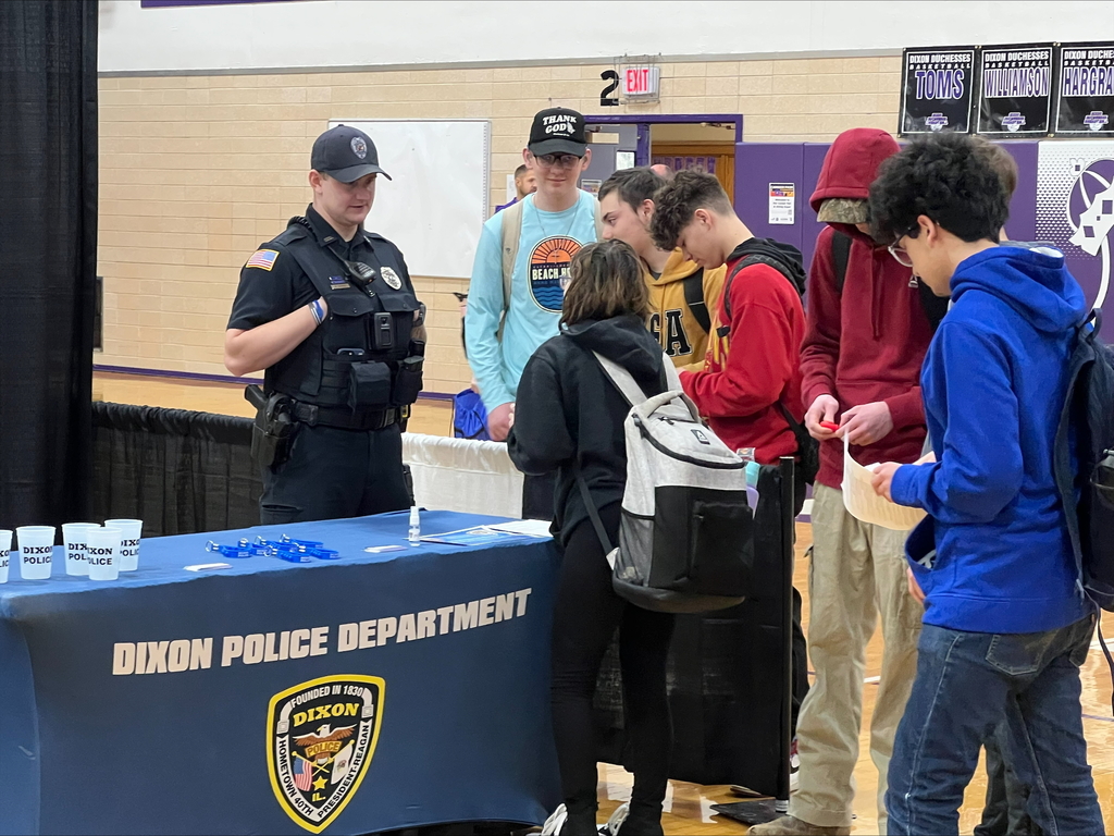 students at career fair listening to speakers at each booth