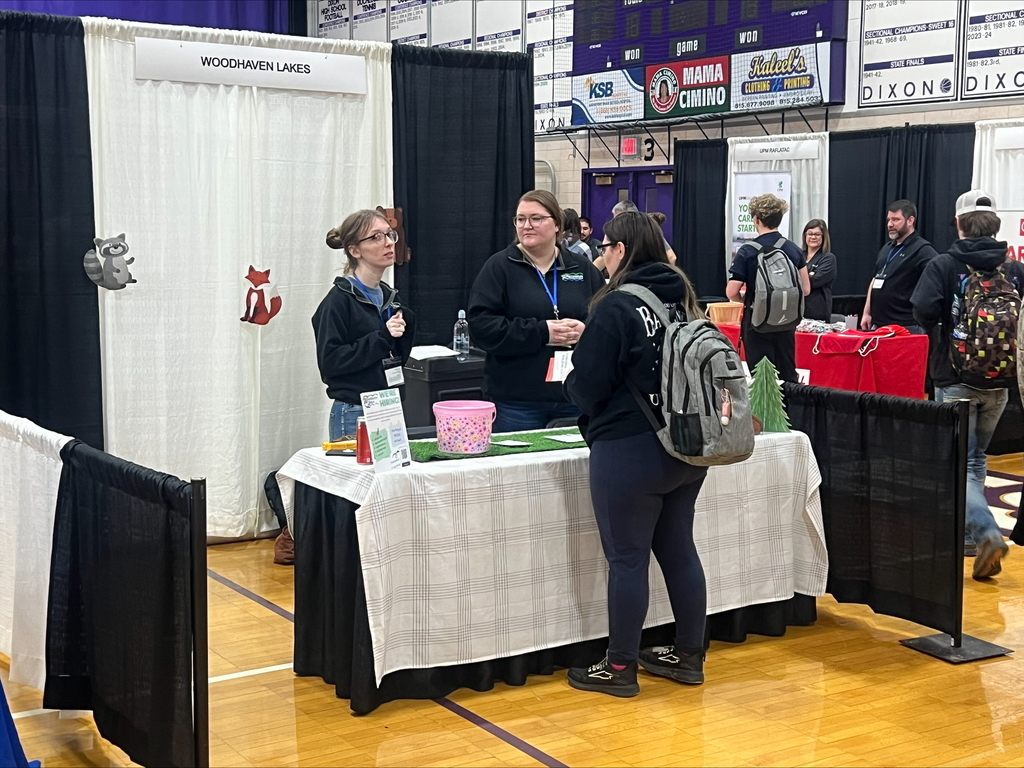 students at career fair listening to speakers at each booth