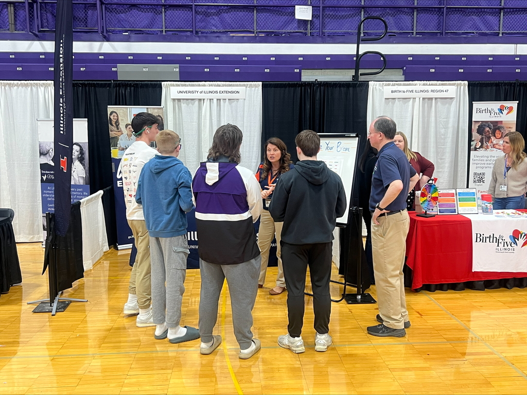 students at career fair listening to speakers at each booth