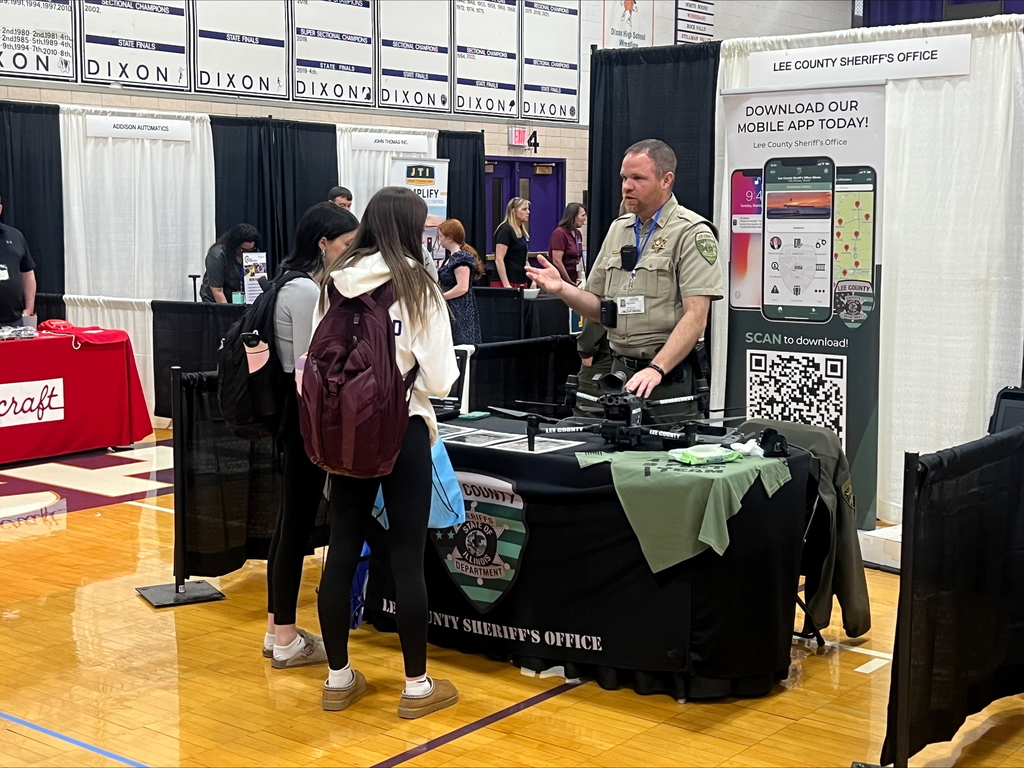students at career fair listening to speakers at each booth