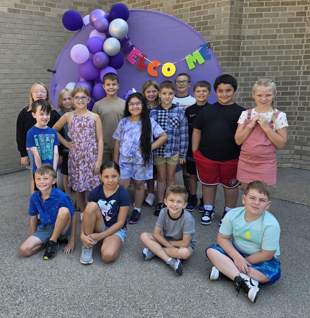 3rd graders posed outside with our welcome sign