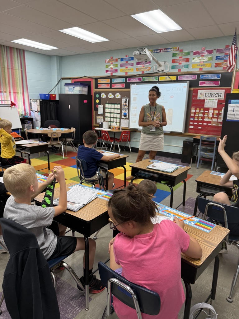 Mrs. Hoyle working with her students discussing was they are grateful
