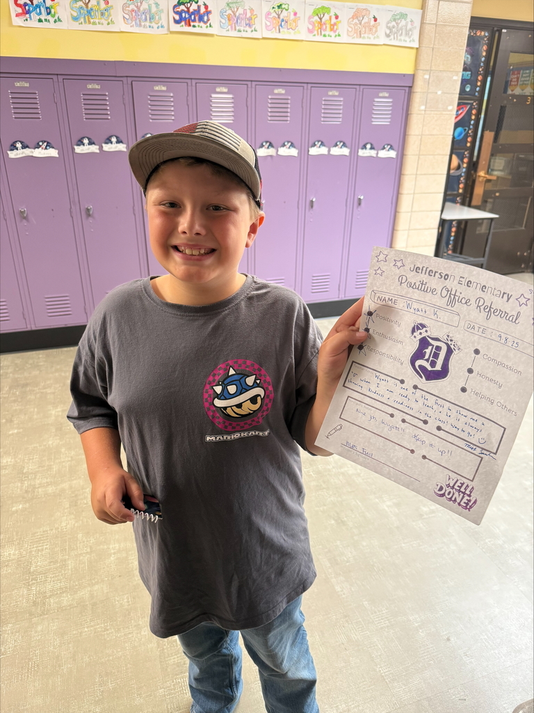 Third grade student with positive office referral certificates and prizes.