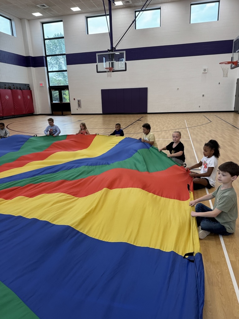 Students in 2nd grade playing with the parachute 