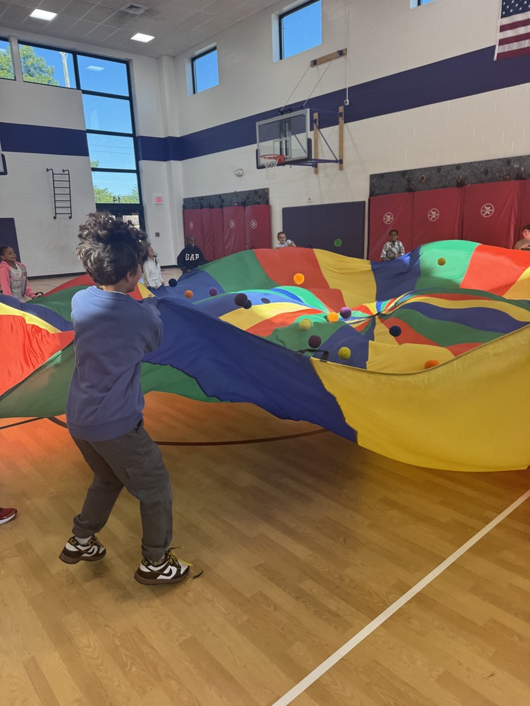 students in 2nd grade playing with the parachute 
