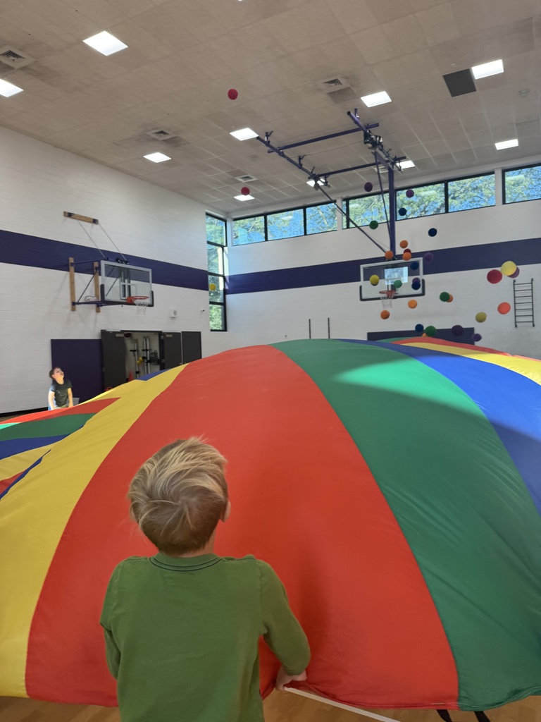 students in 2nd grade playing with the parachute 