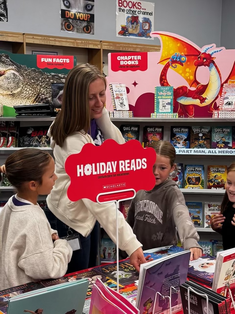 Ms. Saunders and her students look at books