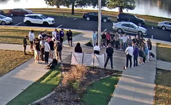 students representing their faith around flag pole