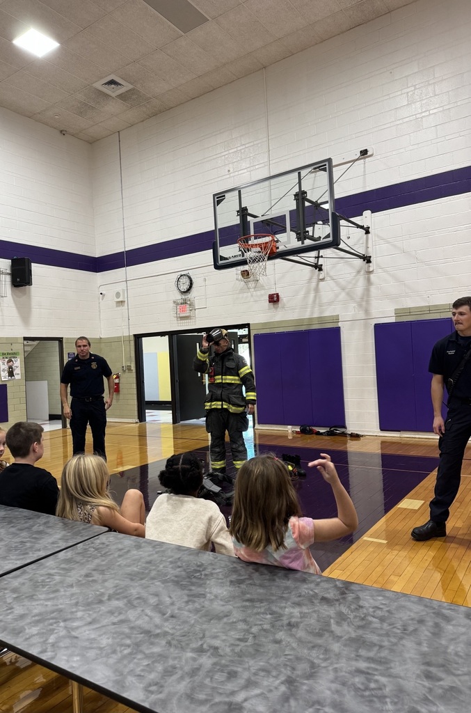 Firefighters explaining to students about fire department gear