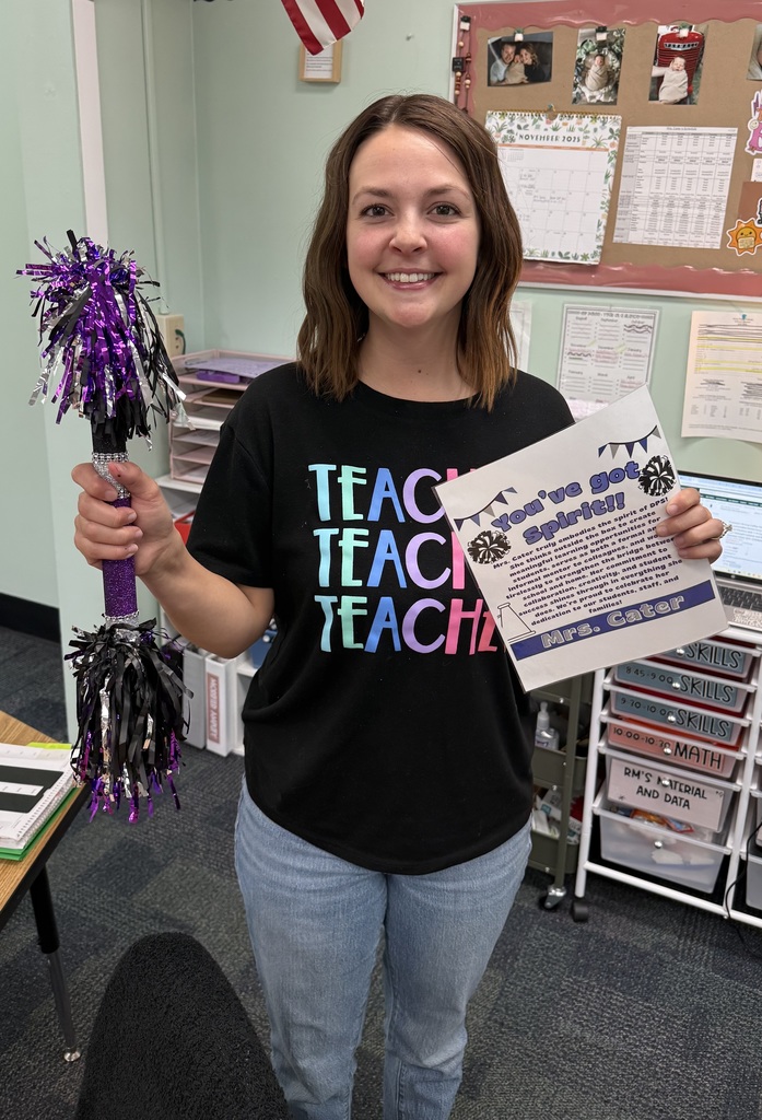 Mrs. Cater with her spirit stick and the certificate.