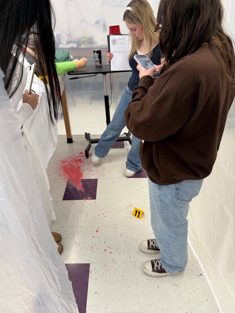 dhs forensic students looking at crime scene