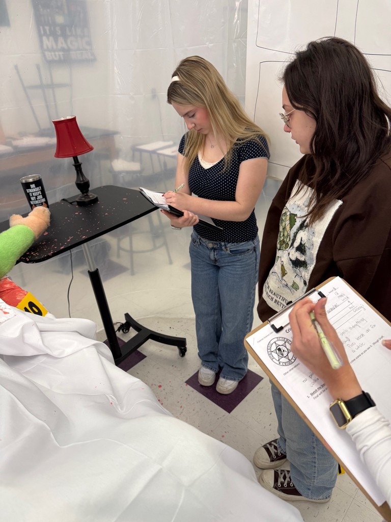 dhs forensic students looking at crime scene