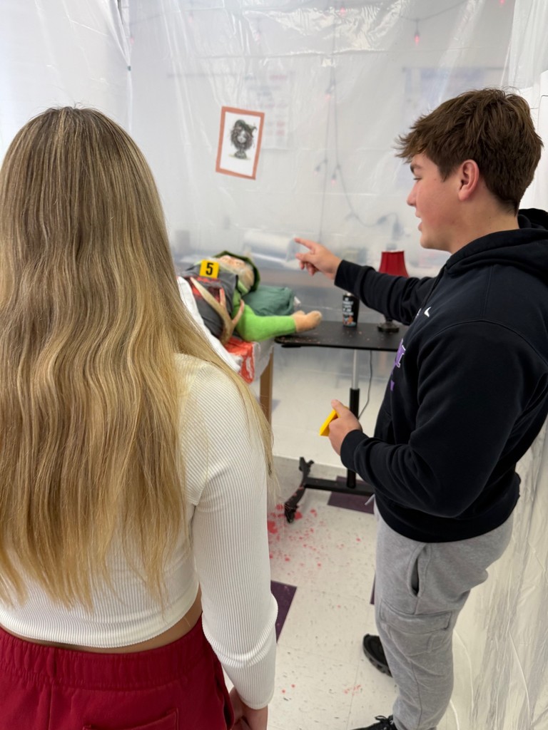 dhs forensic students looking at crime scene