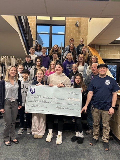 student council giving check to drone soccer