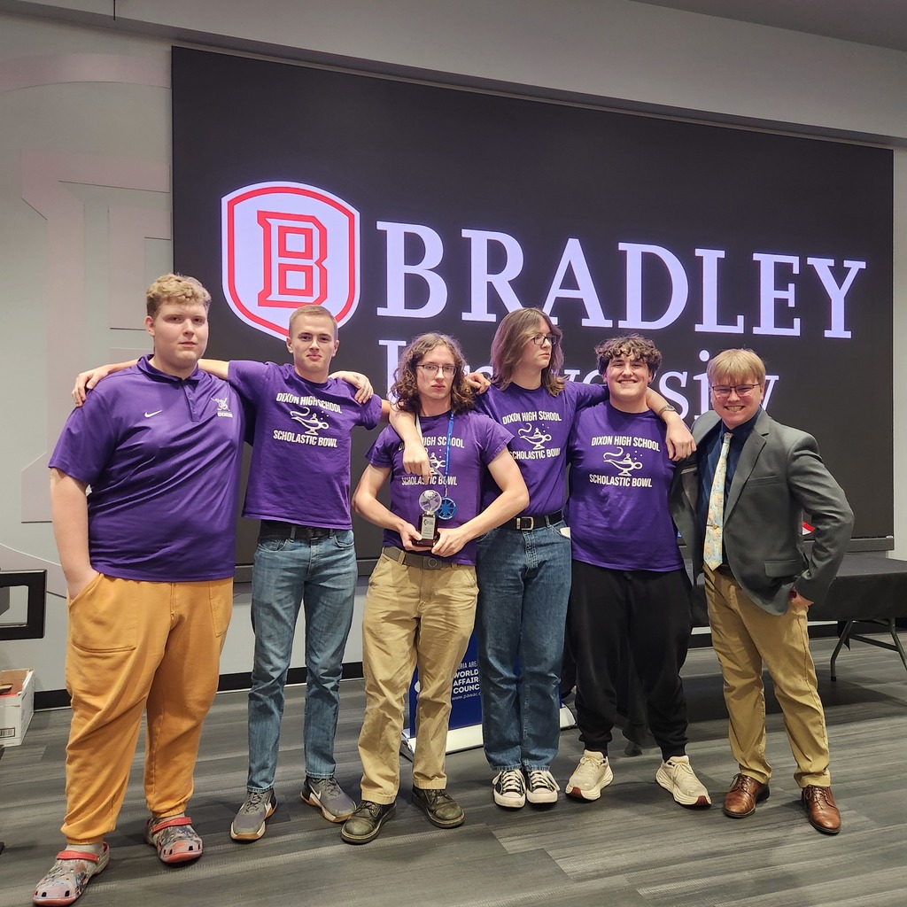 Scholastic Bowl team members posing with trophy at Bradley University