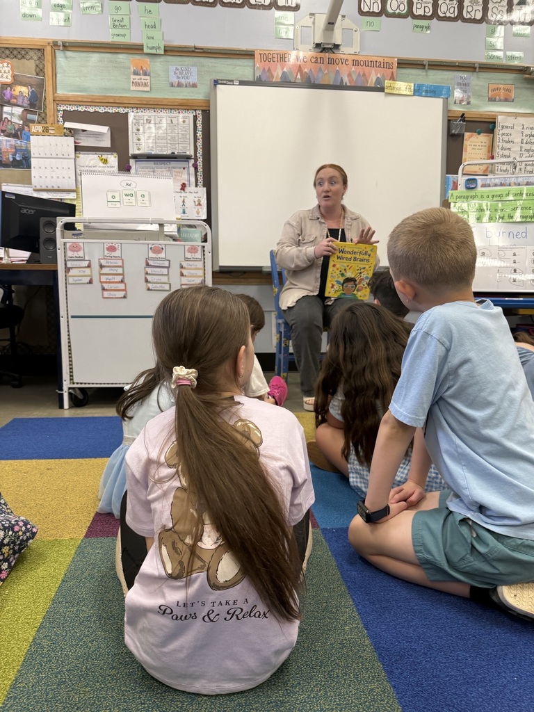 Mrs. Thorpe reading a bout aloud to students 