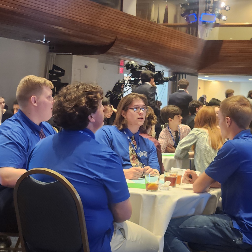 Photo of 4 Scholastic Bowl Members at a table