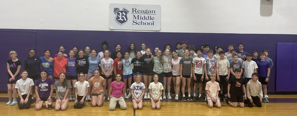 middle school athletes posing for camera