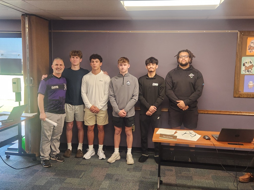 Photo of coach with 5 wrestling students