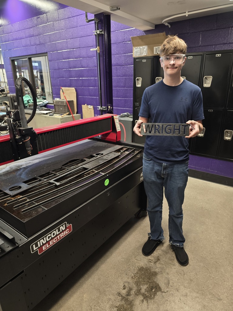 Photo of student with his metals project