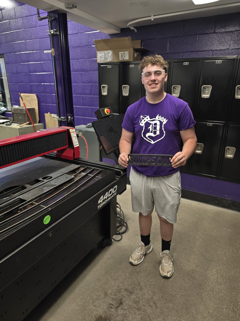 Photo of student with his metals project