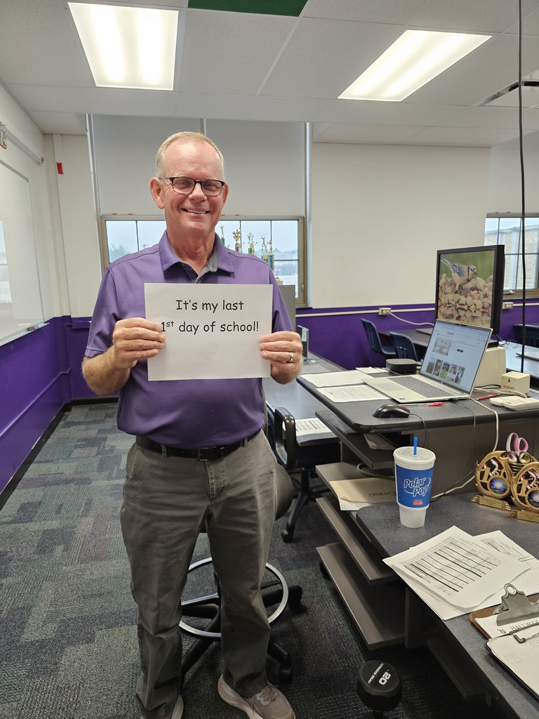 mr eastman holding a sign up for his last day of school teaching