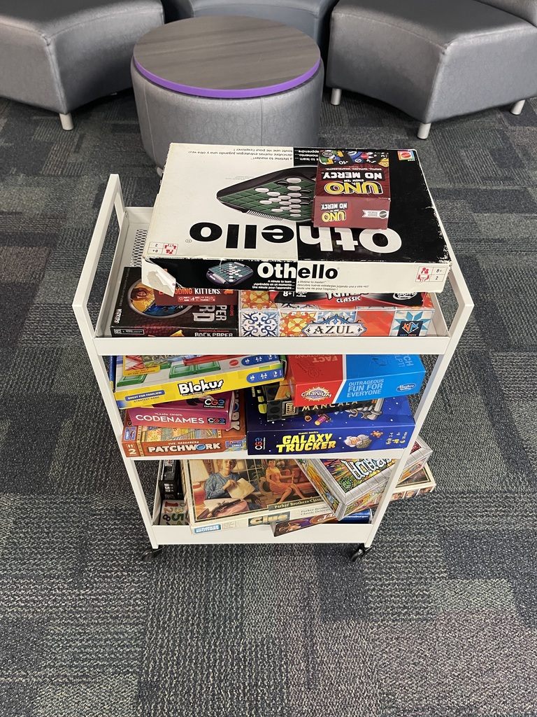 board games stacked on a cart