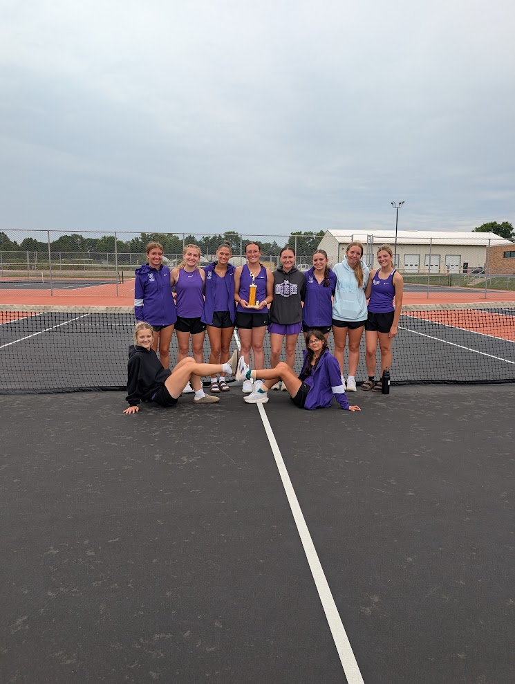 dixon tennis girls won the invite in Freeport holding their trophy