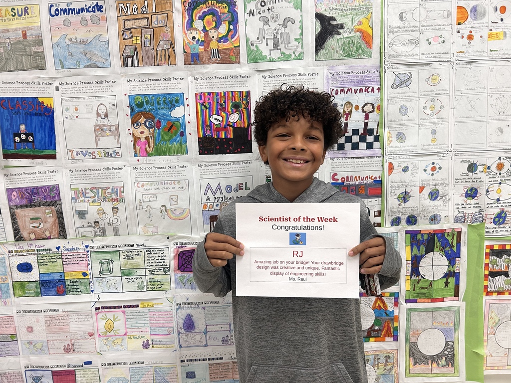 student holding award smiling for camera