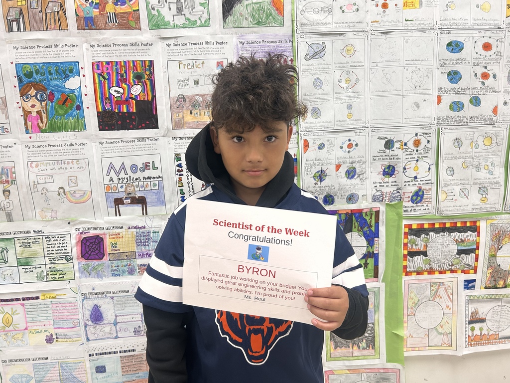 student holding award smiling for camera