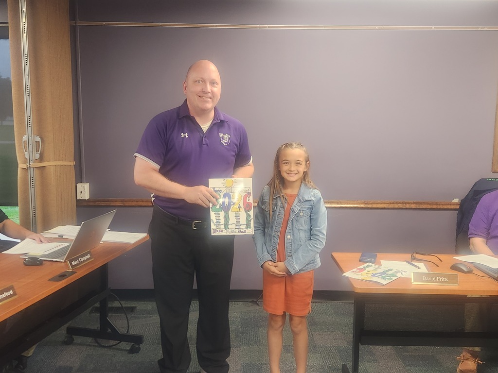 Photo of Principal Sagel and a Young Author at the September Board Meeting