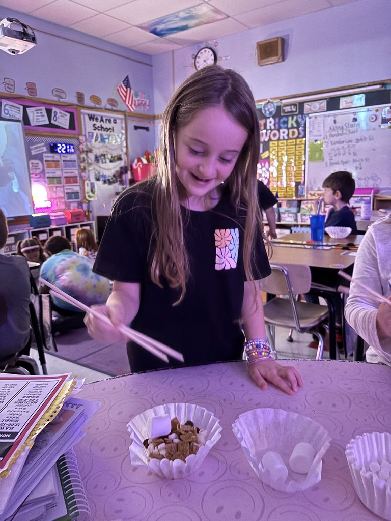 2nd graders using chop sticks 
