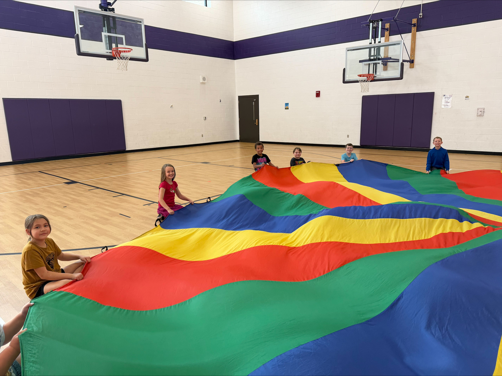 3rd graders playing with the parachute in PE 