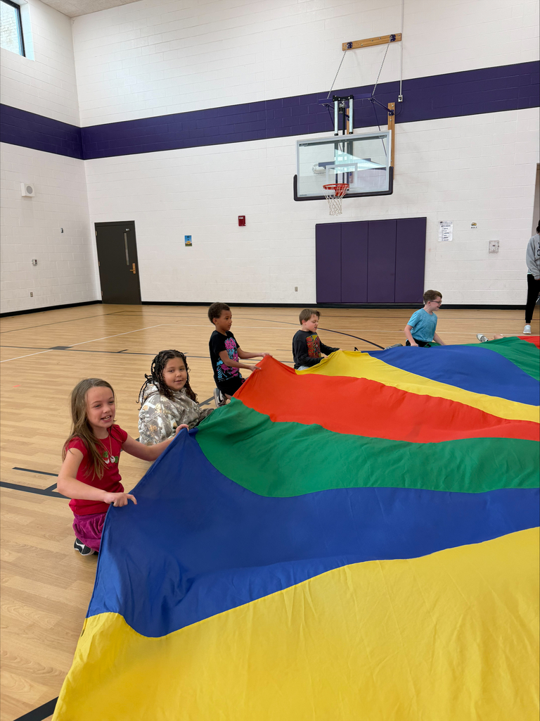 3rd graders playing with the parachute in PE 