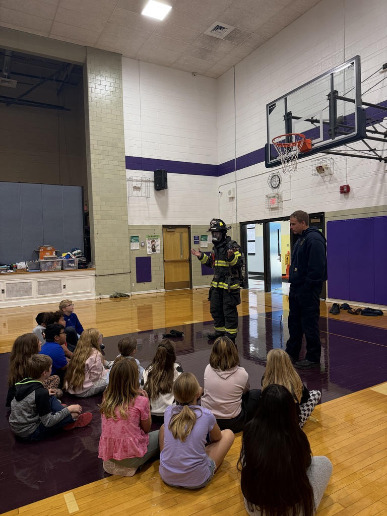 firefighters showing their gear to the third graders