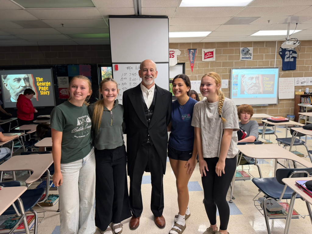 Tom Wadsworth with students smiling for camera