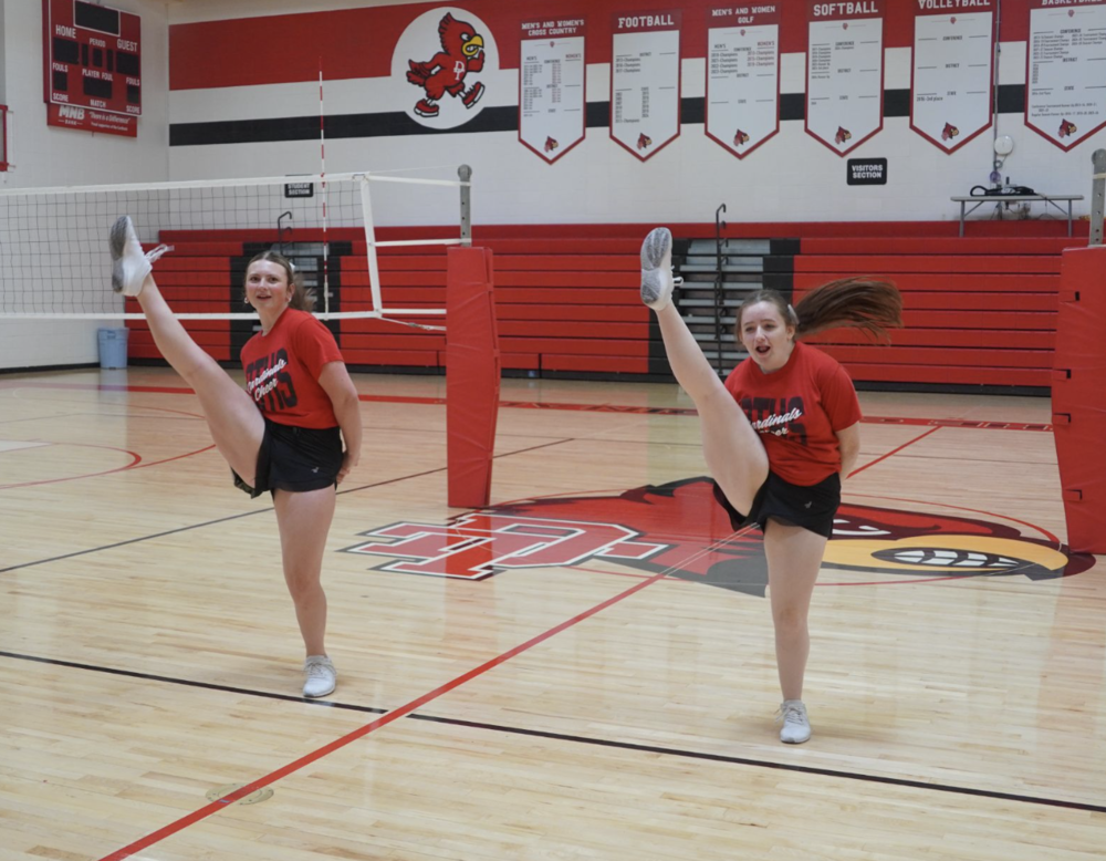 Cheerleaders Katie Christensen and Isabella Wright practice their  kicks for the state routine.