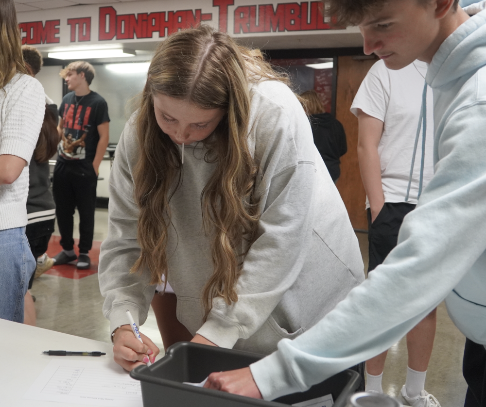 Junior Hailey Hoffman signs up to join FBLA. 