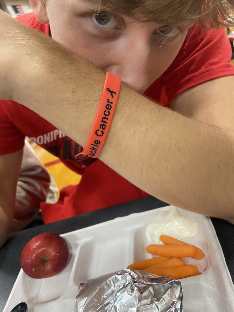 Senior Luke Asky shows his support by purchasing a Tackle Cancer bracelet.