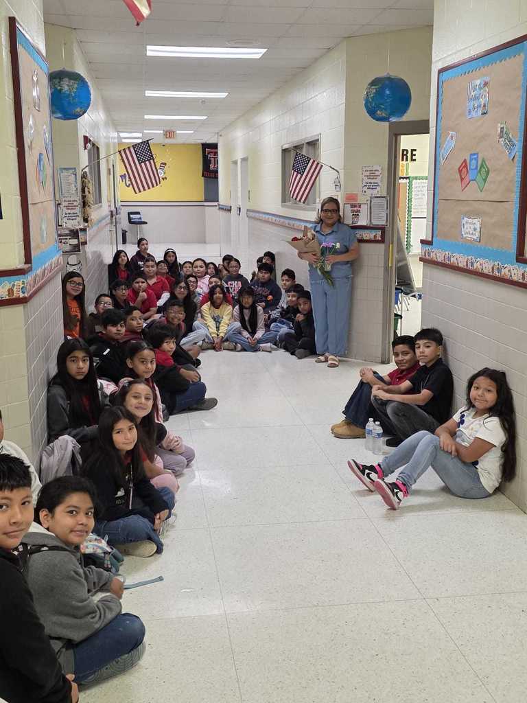 teacher with students sitting down