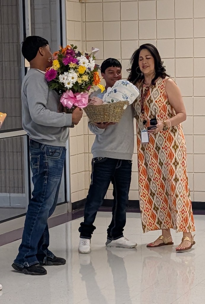 Ms. Zamarron getting flowers and a gift basket